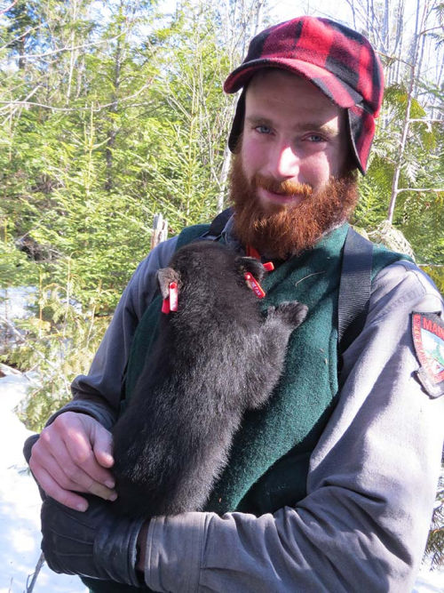 Jake holding a bear cub